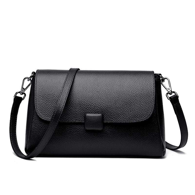 Cowhide Shoulder Bag in black leather with a plain textured finish, flap closure and adjustable shoulder strap