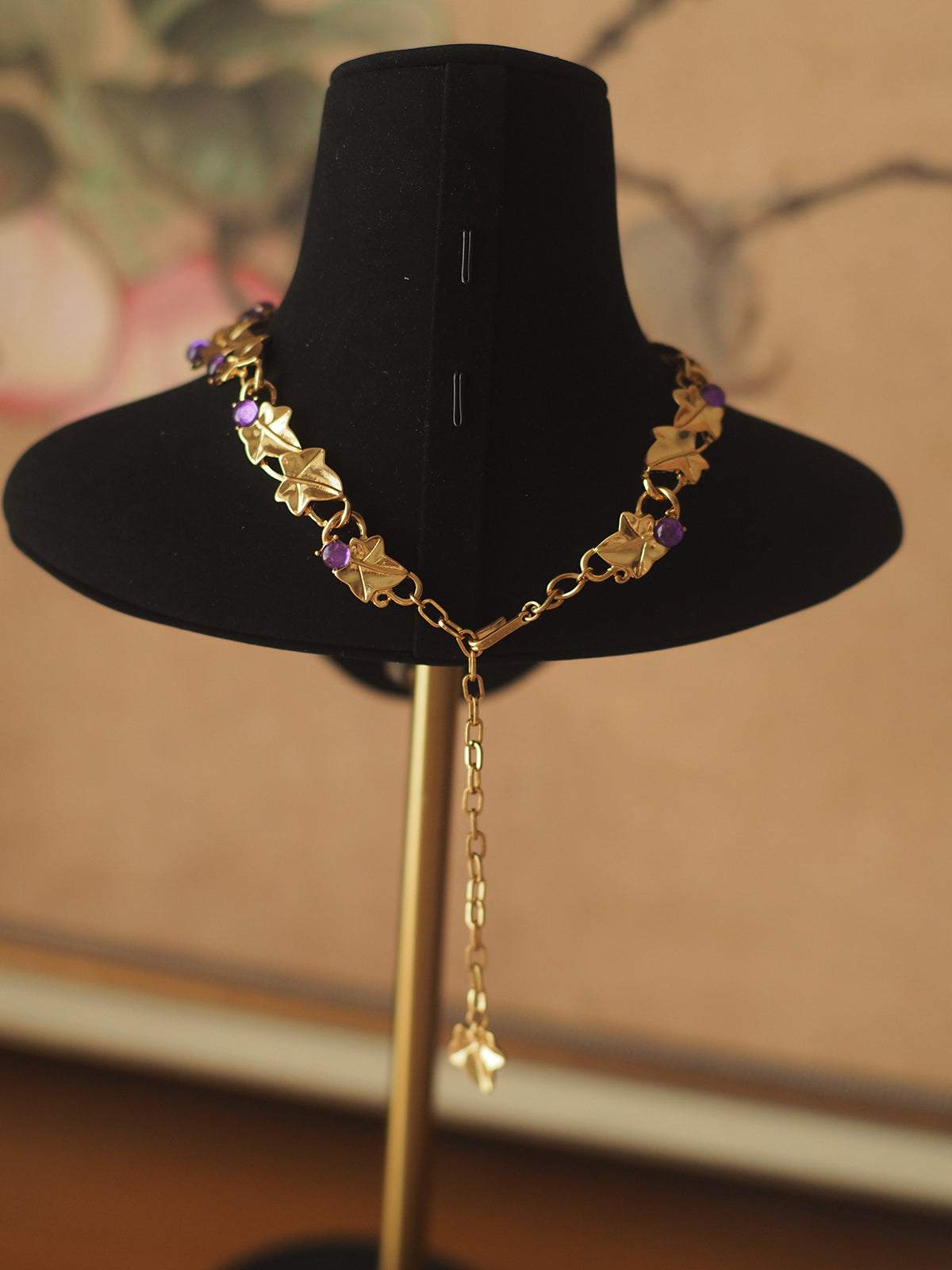 Grape Cluster Gold-Plated Necklace with gold-tone chain, purple and pink faceted stones, and dangling extender