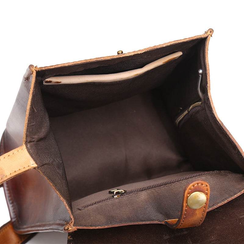 Hand-Painted Cowhide Leather Backpack in brown leather, open to show a spacious lined interior and zipped pocket
