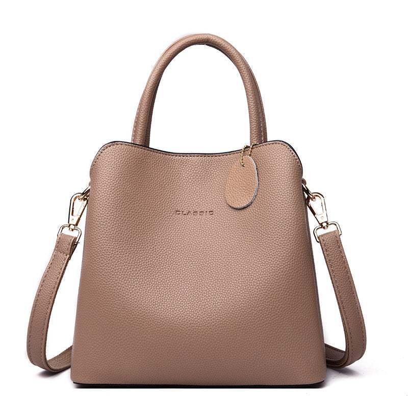 Vegan Leather Bucket Bag in taupe pebbled PU with dual handles, detachable shoulder strap, and round tag