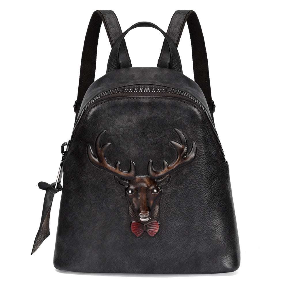Bark-Grain Leather Backpack in black leather with a zip closure and raised deer head bow-tie design