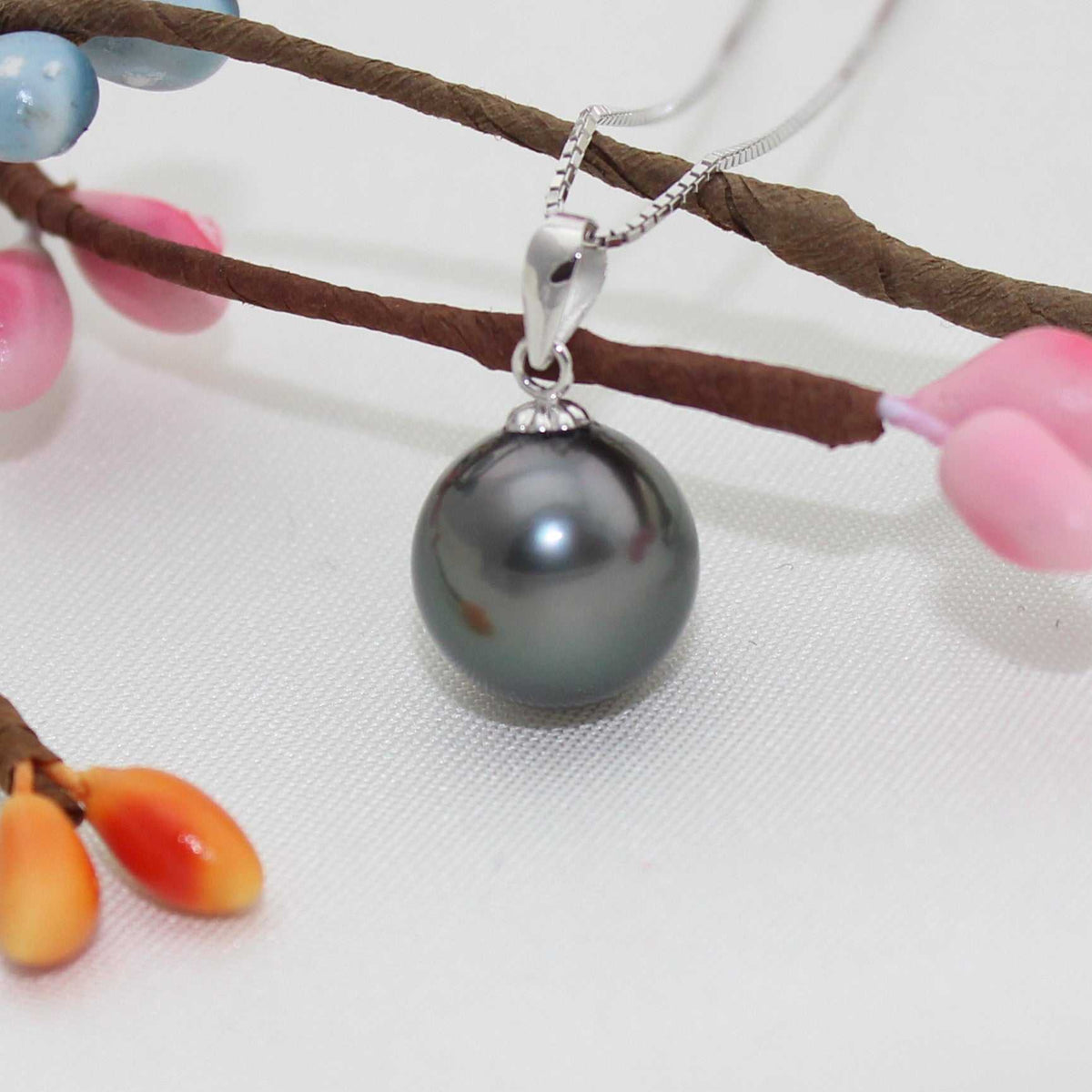 Black pearl pendant with a lustrous round dark grey cultured pearl and a silver-tone bail with gem-set detail