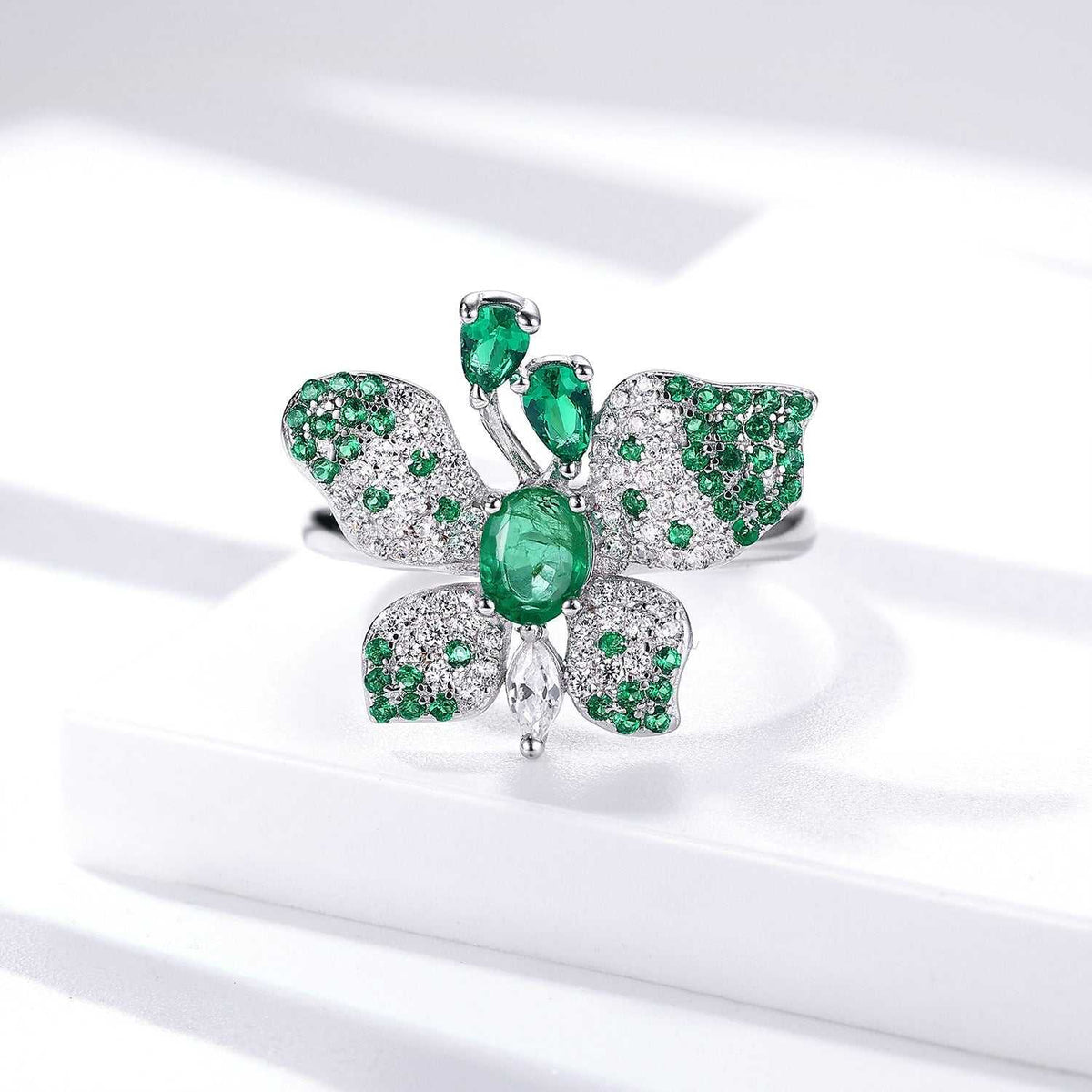 Butterfly Ring in platinum-plated silver with green gemstones, detailed butterfly wings and an oval centre stone