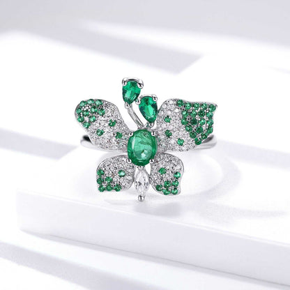 Butterfly Ring in platinum-plated silver with green gemstones, detailed butterfly wings and an oval centre stone