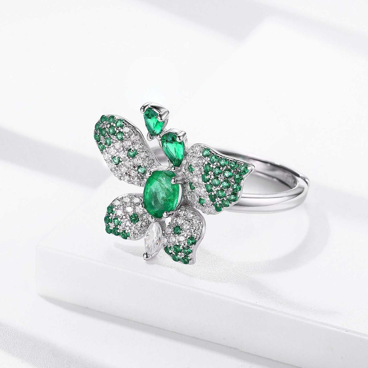Butterfly Ring in silver-tone metal with green oval gemstone and glittering green-and-clear patterned wings