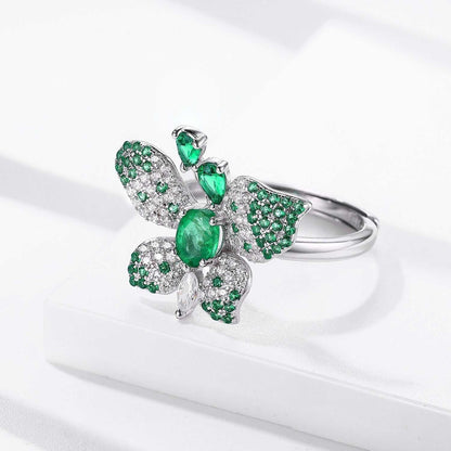 Butterfly Ring in silver-tone metal with green oval gemstone and glittering green-and-clear patterned wings