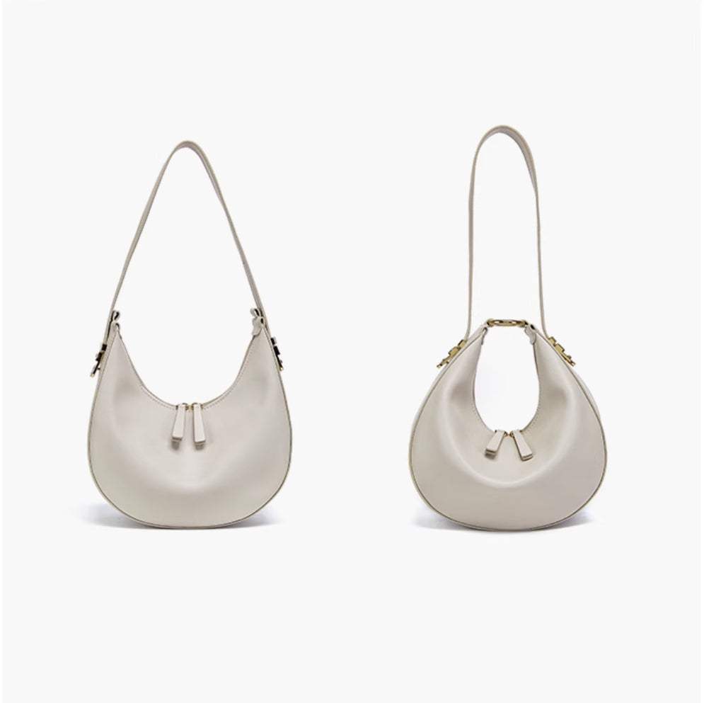 Cowhide Crossbody Bag in pale grey-white smooth leather, with curved hobo shape, zip top and slim strap