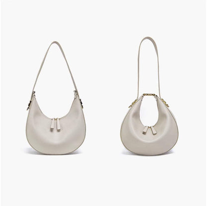 Cowhide Crossbody Bag in pale grey-white smooth leather, with curved hobo shape, zip top and slim strap