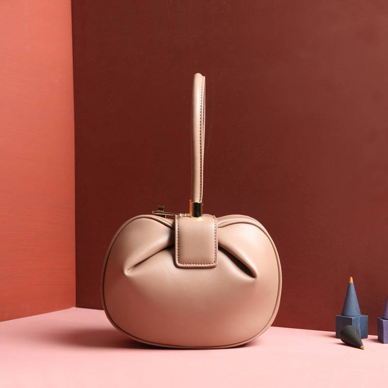 Cowhide Dumpling Tote Bag in blush pink leather with a rounded slouchy shape and single top handle