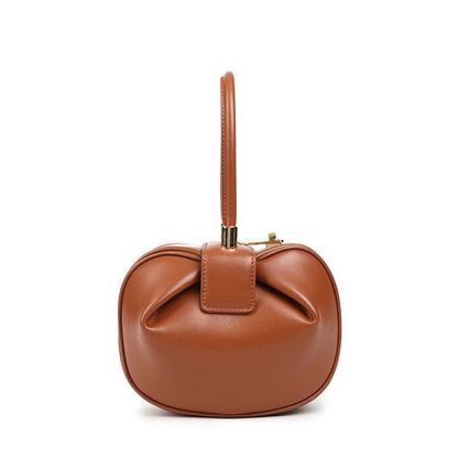 Cowhide Dumpling Tote Bag in caramel brown leather with a soft rounded shape, top handle and buckle closure