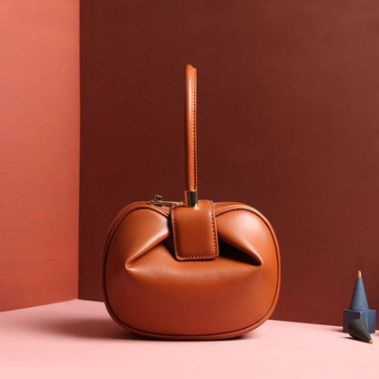 Cowhide Dumpling Tote Bag in caramel leather with a soft rounded shape, folded opening and buckle handle