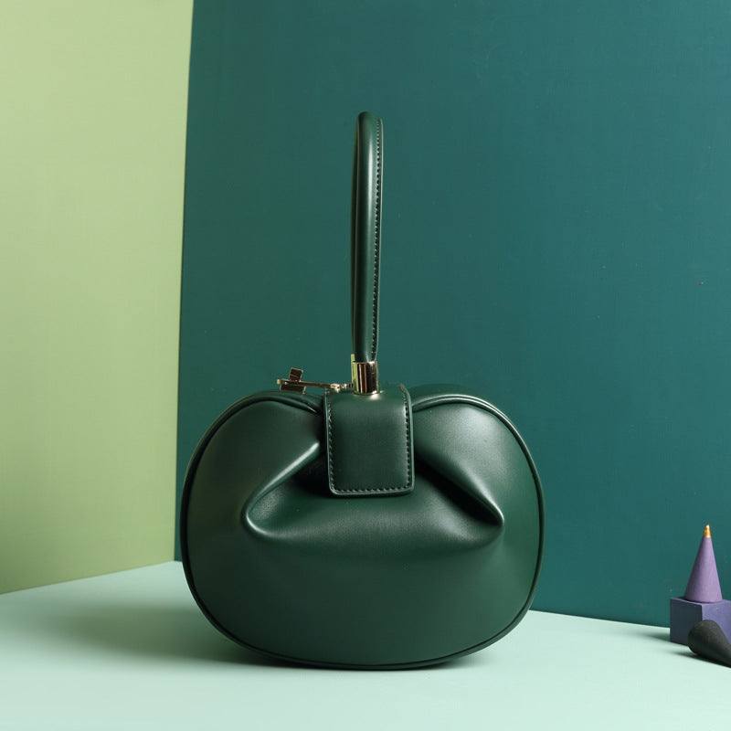 Cowhide Dumpling Tote Bag in dark green leather with a soft rounded shape, single handle and buckle closure