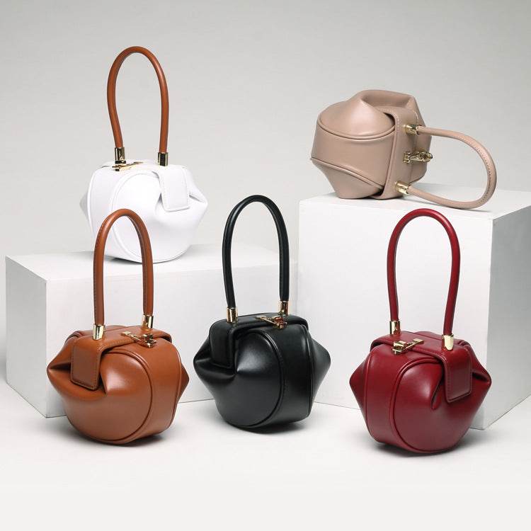 Cowhide Dumpling Tote Bag in brown, black, red, white and pink leather with rounded shape and single handles