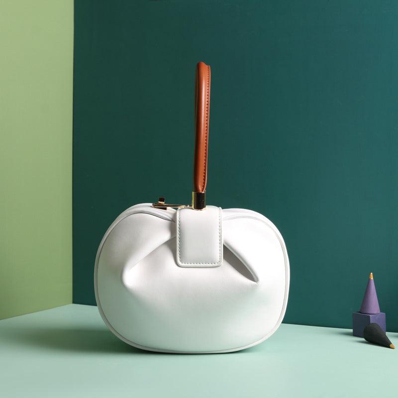 Cowhide Dumpling Tote Bag in white leather with soft rounded shape, buckle closure and single handle