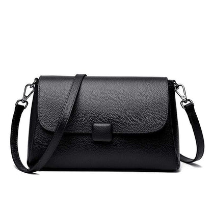 Cowhide Shoulder Bag in black leather with a plain textured finish, flap closure and adjustable shoulder strap