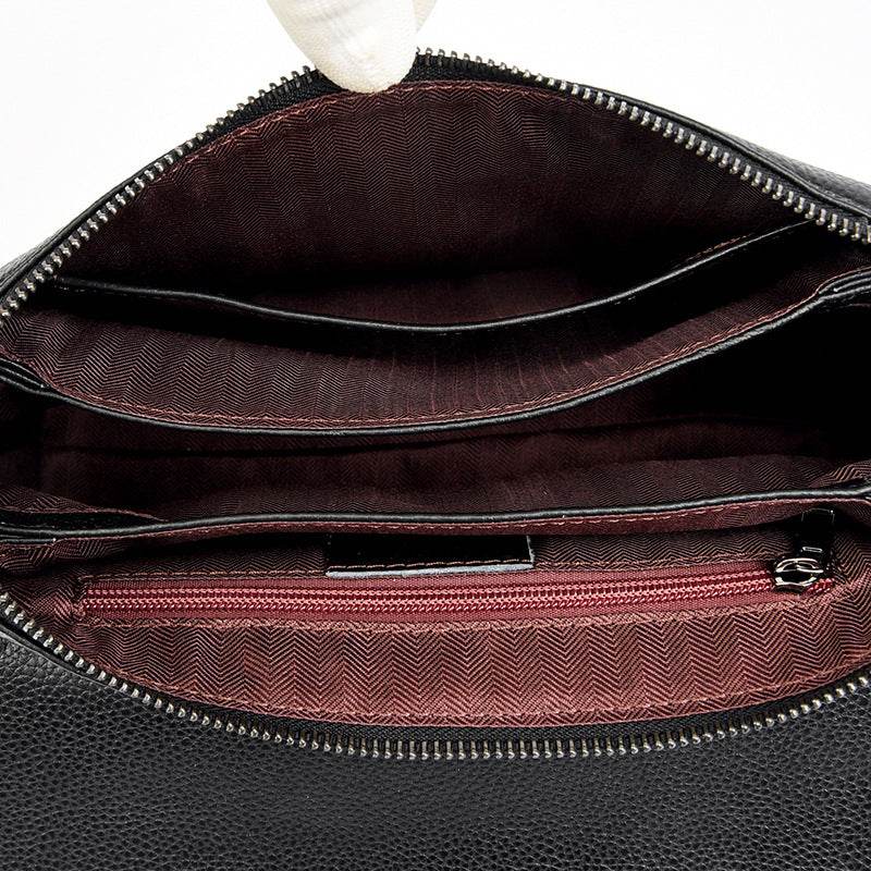 Cowhide Shoulder Bag in black leather with a soft interior, zipped compartment, document slot and patterned lining