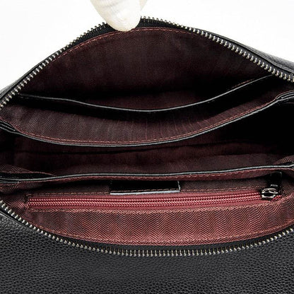 Cowhide Shoulder Bag in black leather with a soft interior, zipped compartment, document slot and patterned lining