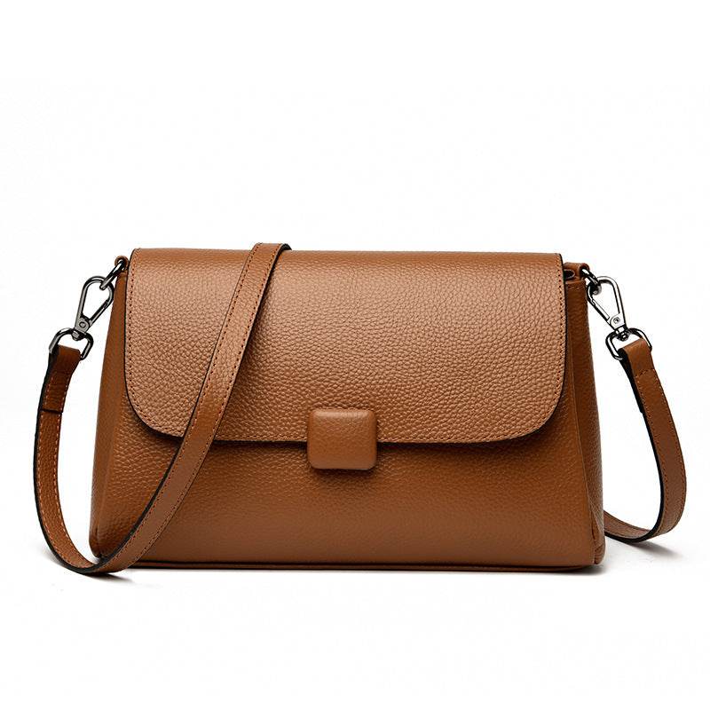 Cowhide Shoulder Bag in caramel brown leather with pebbled texture, flap closure and adjustable shoulder strap