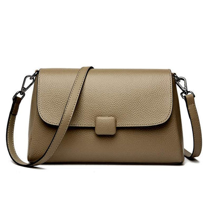 Cowhide Shoulder Bag in taupe brown leather with pebbled texture, flap closure, and adjustable shoulder strap