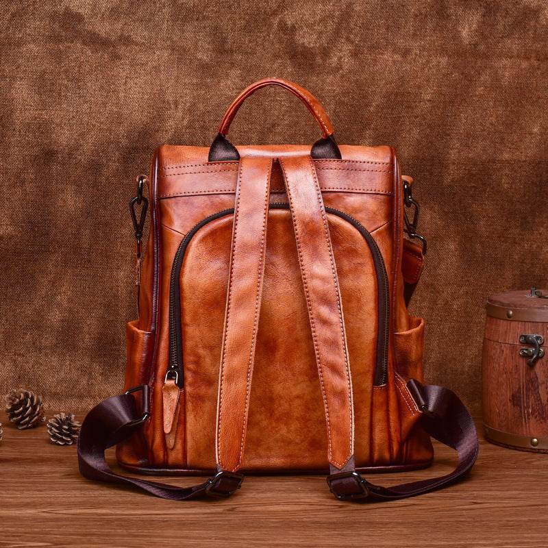 Cowhide Travel Backpack in rich brown leather with distressed finish, zip front pocket, top handle and twin straps
