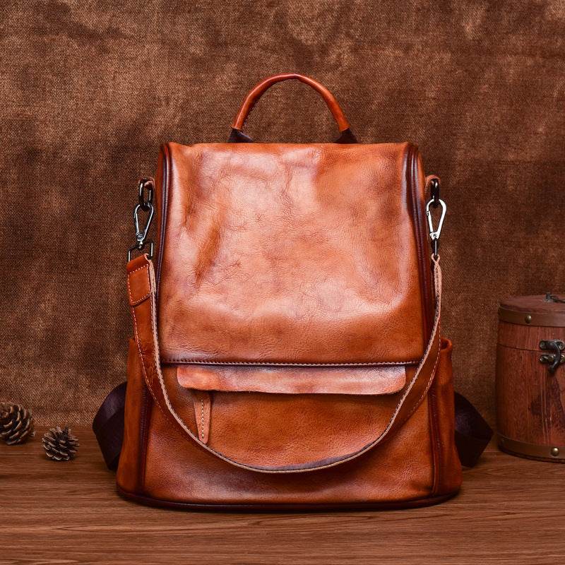 Cowhide Travel Backpack in soft brown leather with a rubbed finish, flap front, top handle and shoulder straps