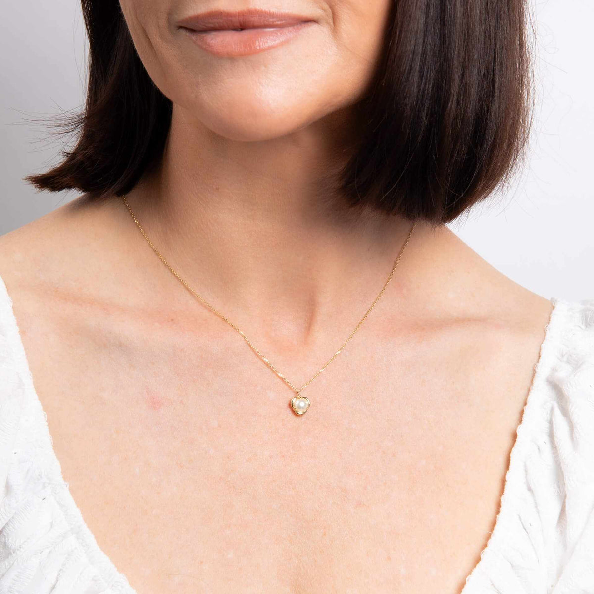 Elements Gold Pearl Necklace in yellow gold with a single pearl in a delicate petal-shaped pendant