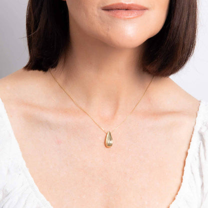 Elements Gold ridged teardrop necklace in polished yellow gold with a slim chain and textured pendant