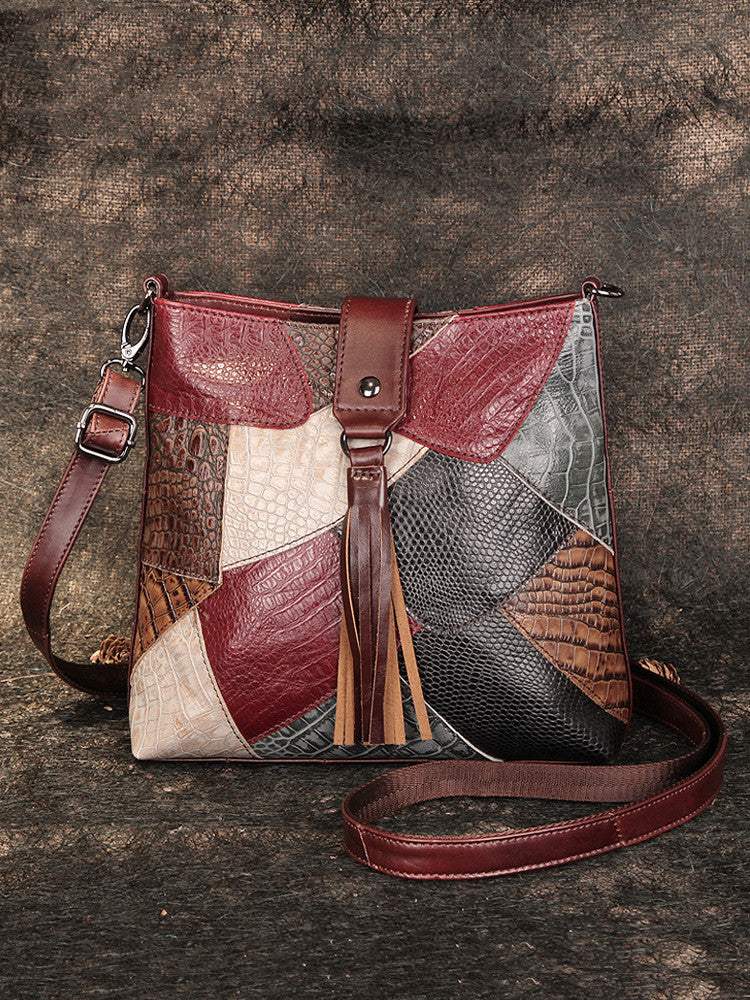 Full-Grain Leather Bucket Bag in burgundy patchwork leather with textured panels, zip top, strap and long fringe