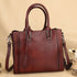 Full-Grain Leather Shoulder Bag in burgundy leather with woven side panels, double handles, and detachable strap