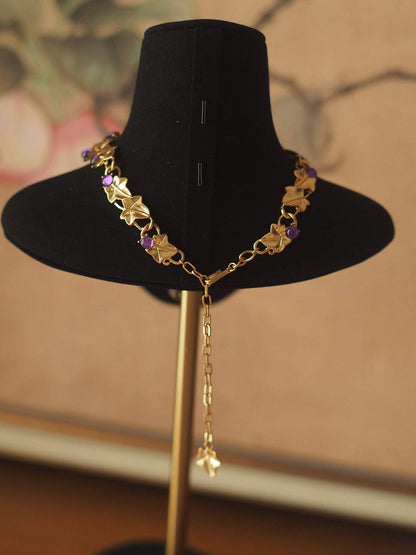 Grape Cluster Gold-Plated Necklace with gold-tone chain, purple and pink faceted stones, and dangling extender