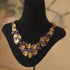 Grape Cluster Gold-Plated Necklace with purple faceted stones and layered gold-tone leaf charms