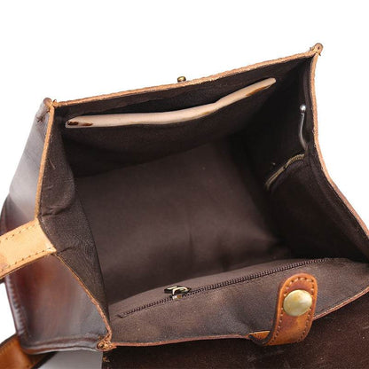 Hand-Painted Cowhide Leather Backpack in brown leather, open to show a spacious lined interior and zipped pocket