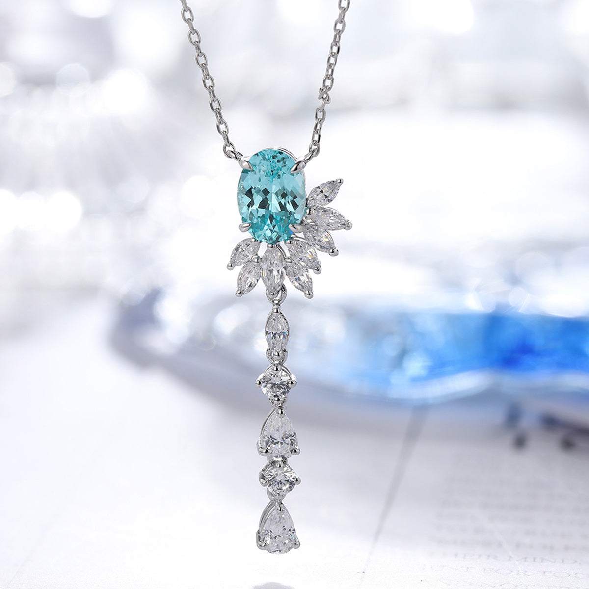 Lab-Created Gemstone Lariat Necklace in silver with vivid aqua-blue oval stone and cascading clear mixed-cut accents