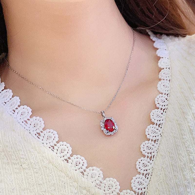Lab-Created Ruby Halo Pendant Necklace with a vivid red oval stone, sparkling clear halo and delicate silver chain