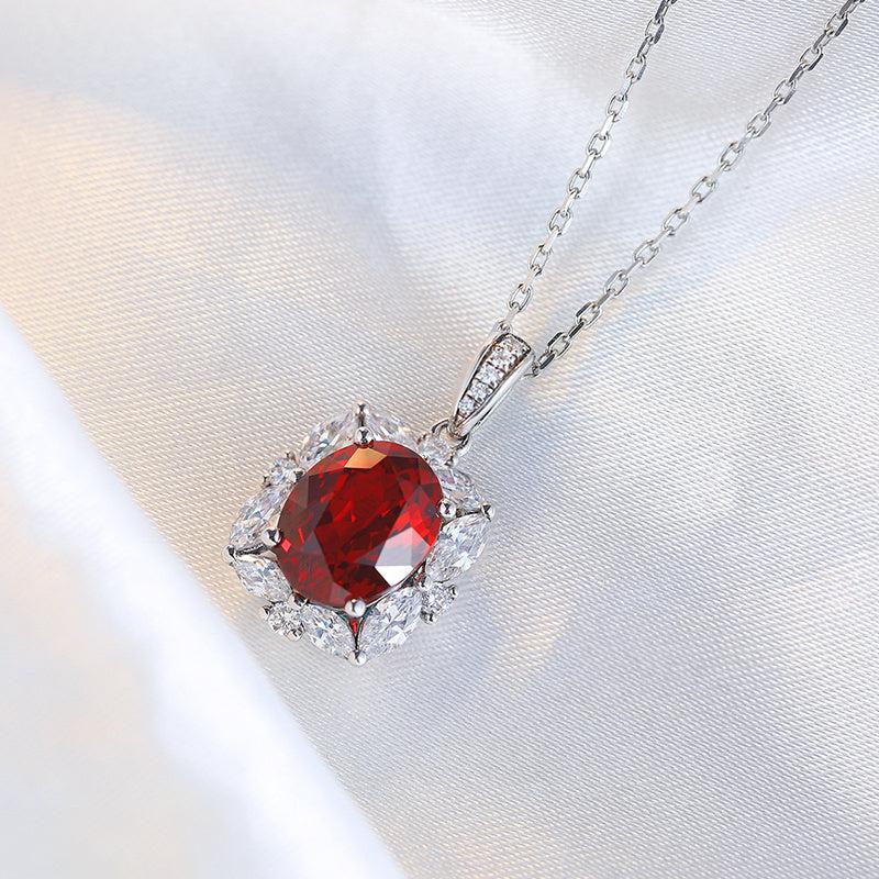 Lab-Created Ruby Halo Pendant Necklace with oval deep red gemstone, silver chain and sparkling clear halo accents