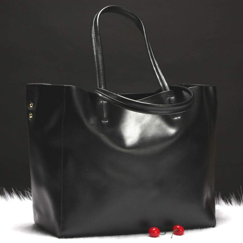 Metallic Cowhide Shoulder Bag in black leather with a soft-sided shape, twin handles, and detachable strap