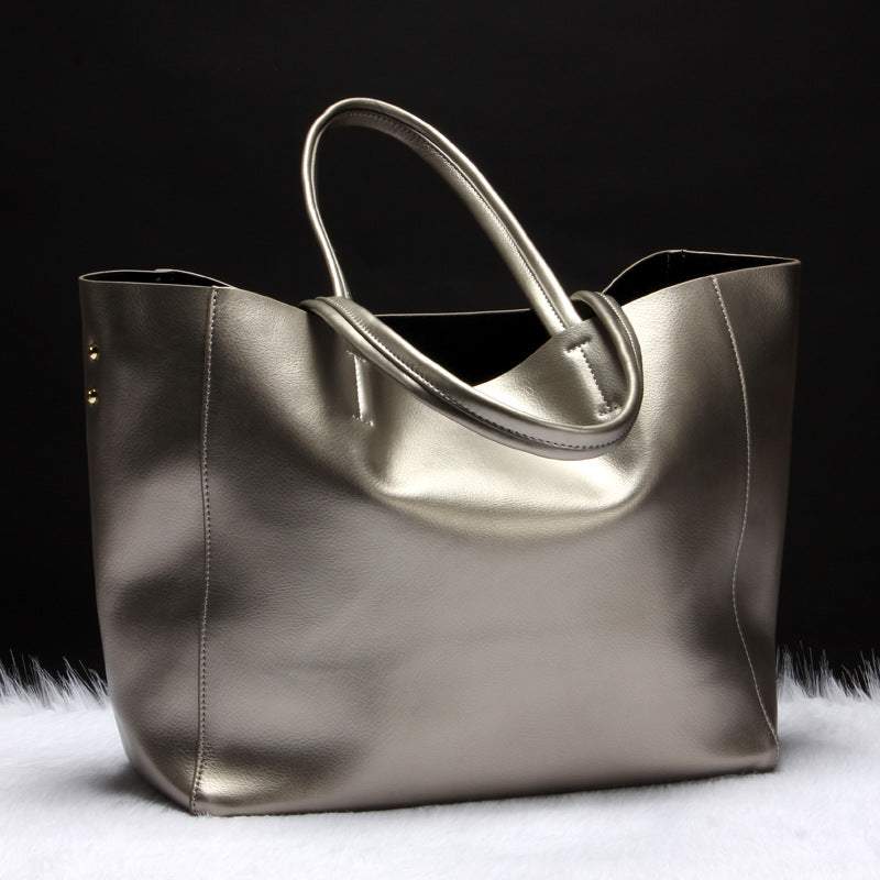 Metallic Cowhide Shoulder Bag in bronze leather with smooth finish, soft-sided design and twin handles