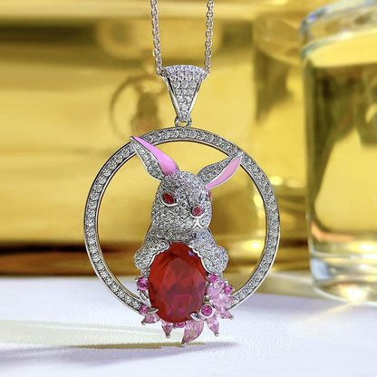 Rabbit Pendant Necklace with a silver-tone pavé rabbit, pink inner ears, red eyes and large faceted red stone