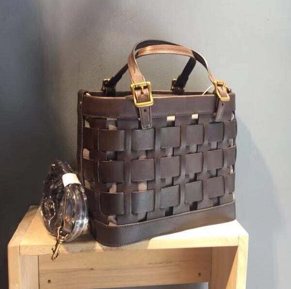 Soft Cowhide Messenger Bag in dark brown leather with a woven openwork panel, short handles and gold-tone buckles