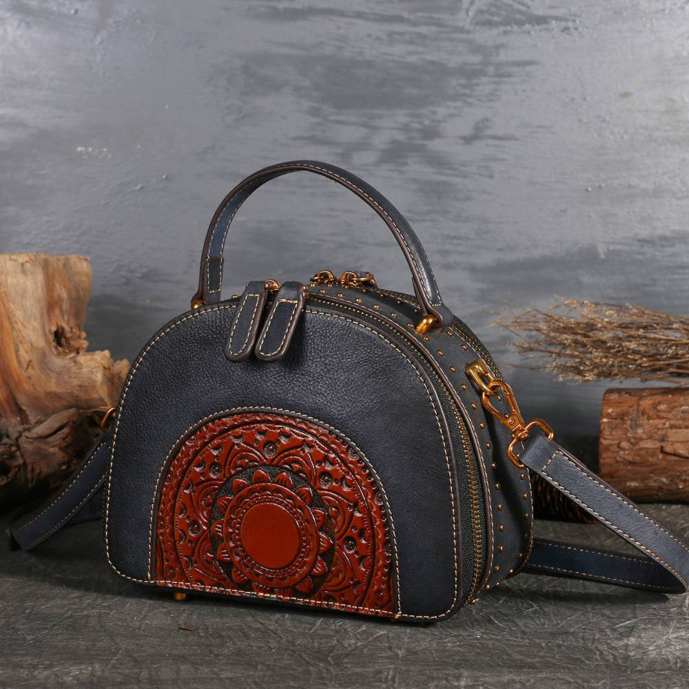 Suede Cowhide Top-Handle Handbag in black with a red embossed paisley panel, top handle and shoulder strap