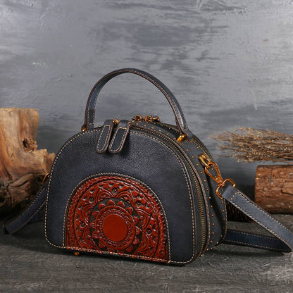 Suede Cowhide Top-Handle Handbag in black with a red embossed paisley panel, top handle and shoulder strap