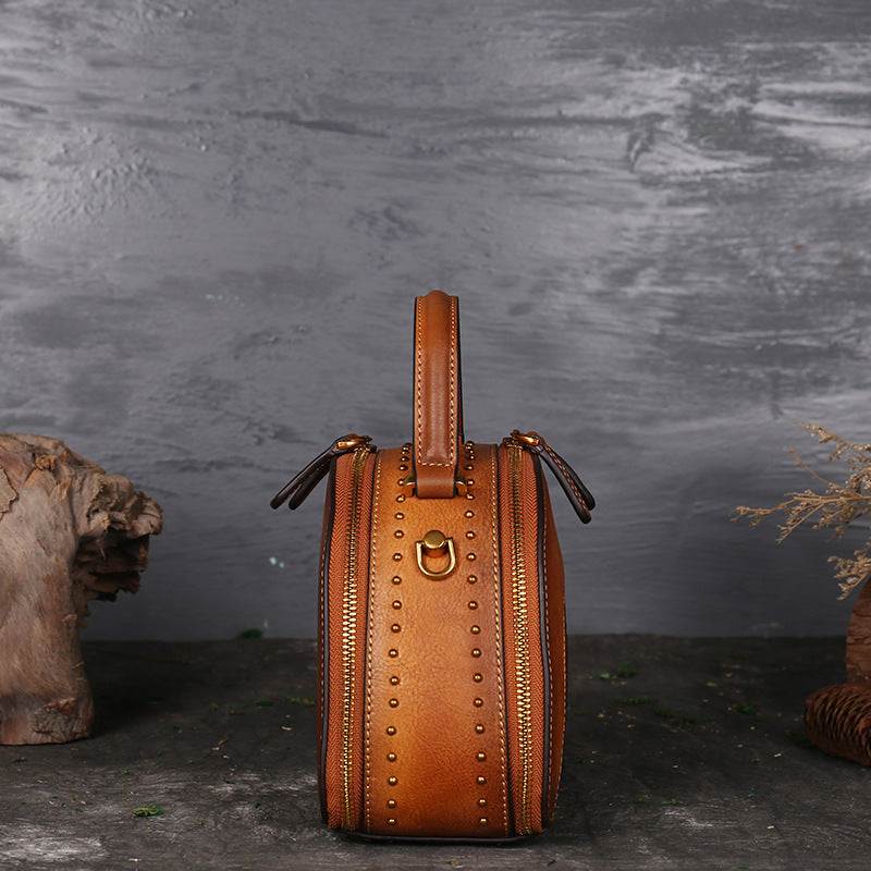 Suede Cowhide Top-Handle Handbag in warm brown with studded detailing, dual zippers and a structured top handle