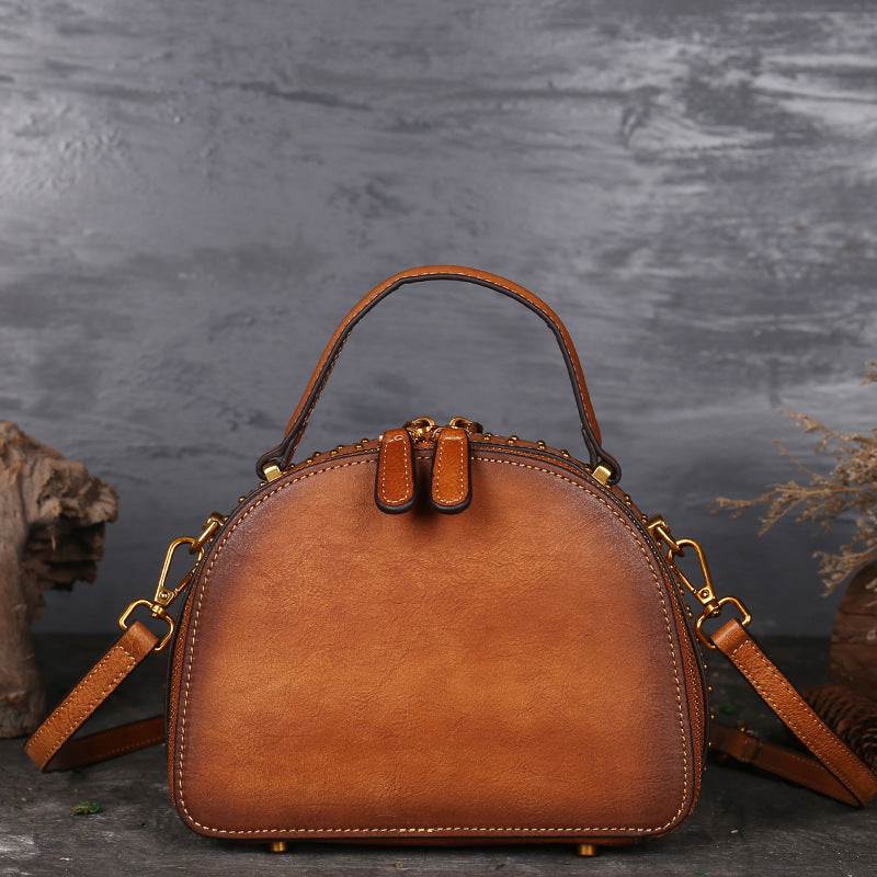 Suede Cowhide Top-Handle Handbag in warm orange-brown with a rounded structured shape and detachable shoulder strap