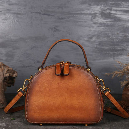 Suede Cowhide Top-Handle Handbag in warm orange-brown with a rounded structured shape and detachable shoulder strap