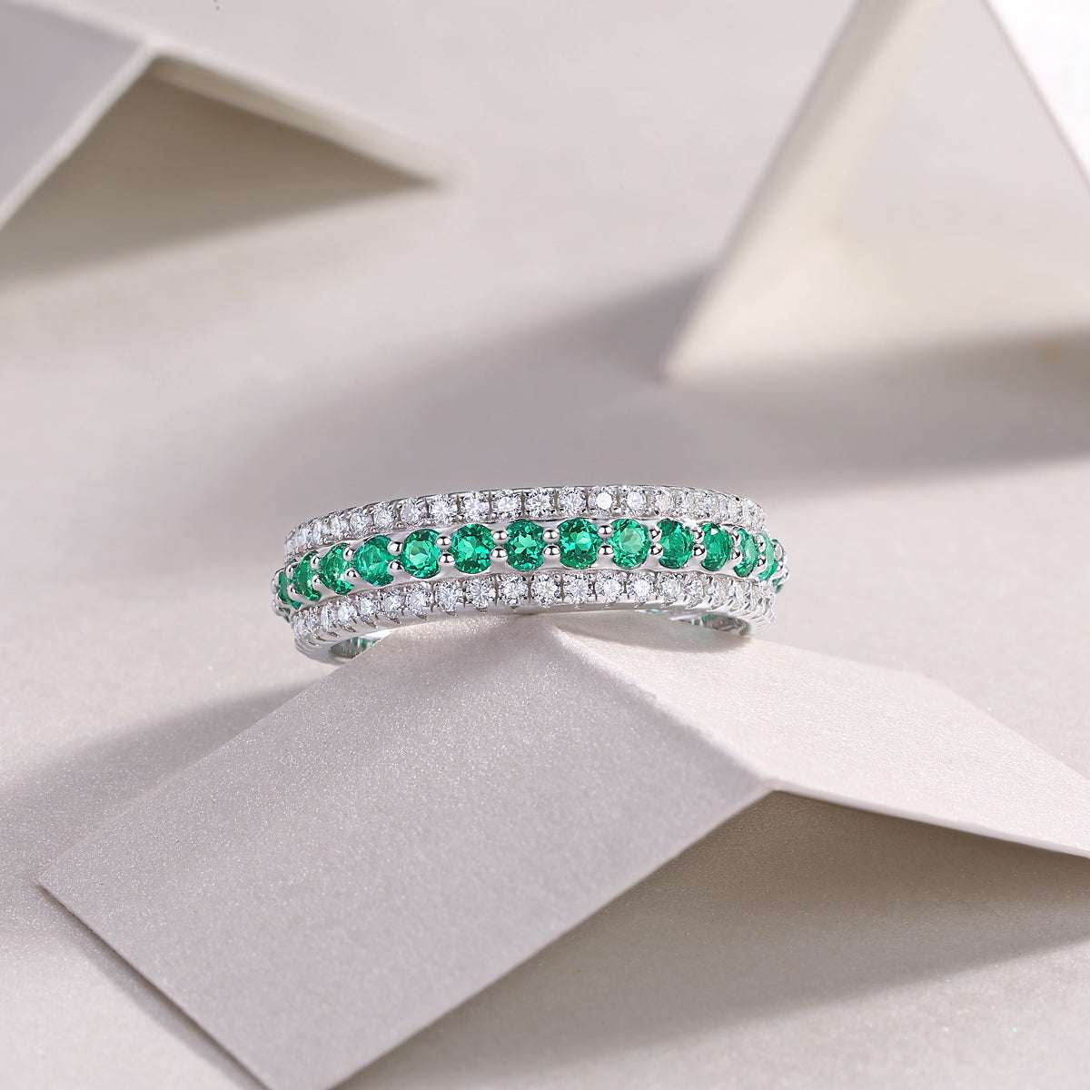 Three-Row Pavé Eternity Ring in silver-tone metal with three rows of pavé stones, green centre row and white stones