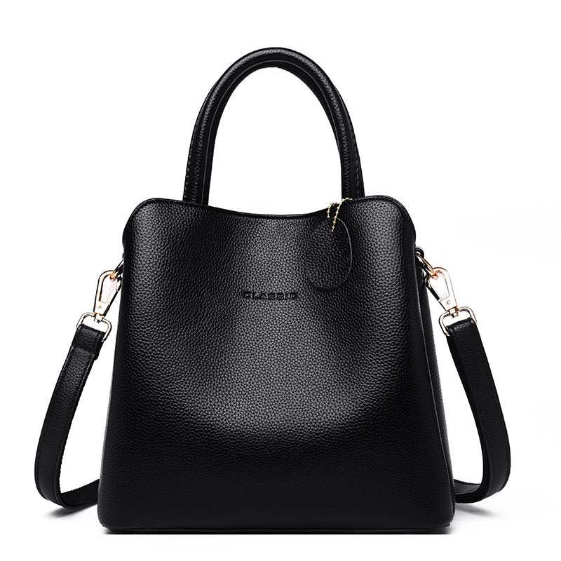 Vegan Leather Bucket Bag in black pebbled PU with a structured shape, top handle, zip closure and shoulder strap
