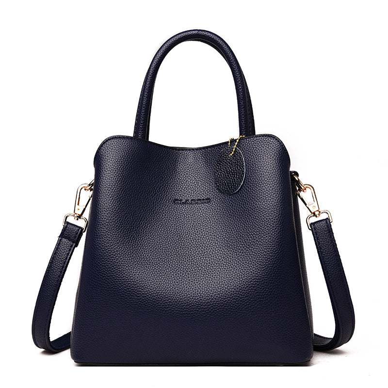 Vegan Leather Bucket Bag in dark navy pebbled vegan leather with a structured shape, top handle and detachable shoulder strap