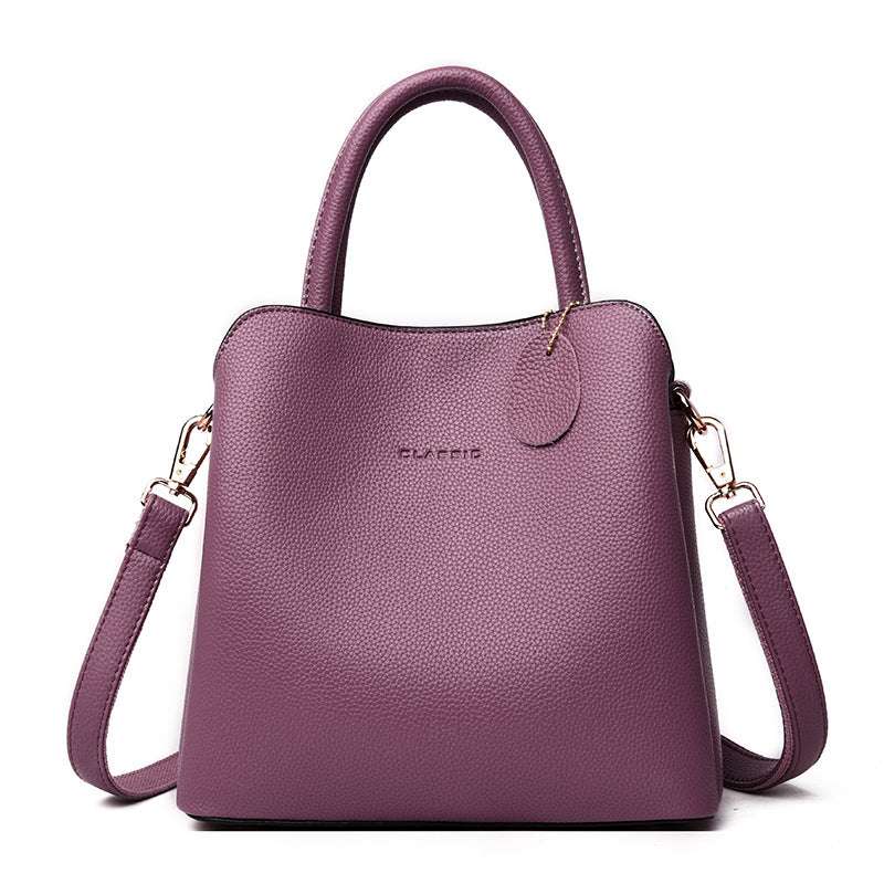 Vegan Leather Bucket Bag in purple litchi-grain vegan leather with a structured shape, top handle and shoulder strap