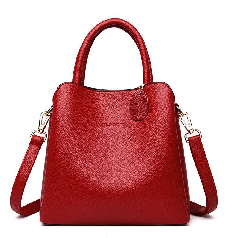 Vegan Leather Bucket Bag in red pebbled PU with a structured shape, top handles, and detachable shoulder strap