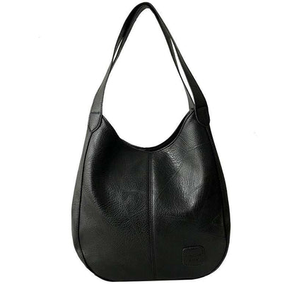 Vegan Leather Tote Bag in black with soft textured finish, curved shape, long shoulder straps and front logo patch